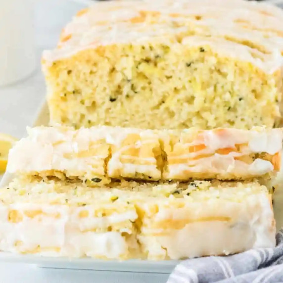 Lemon yellow loaf cake sliced topped with glaze