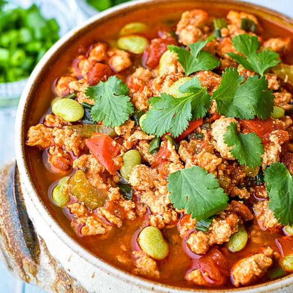 a bowl of instant pot / slow cooker buffalo chicken chili garnished with cilantro leaves