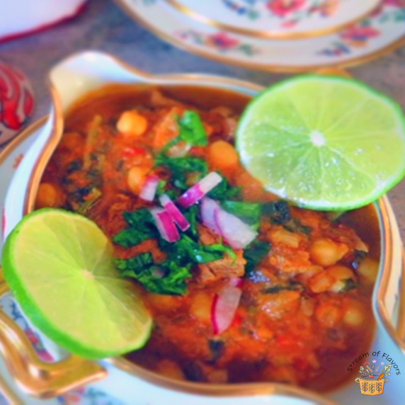 Moroccan Lamb Soup with chickpease, tomatoes, spices, harissa, lime, and cilantro in a soup bowl
