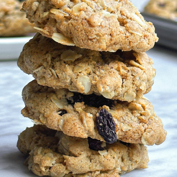 stacked vegan oatmeal raisin cookies on a marble surface