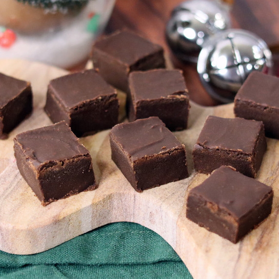 Pieces of old fashioned fudge arranged on a holiday plate against a white background