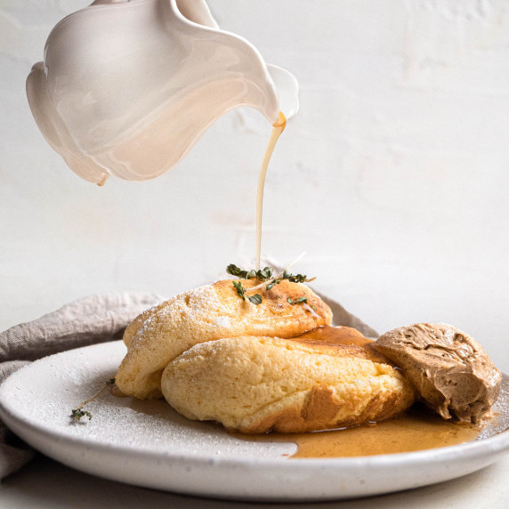 fluffy souffle pancakes topped with whipped gingerbread butter and maple syrup