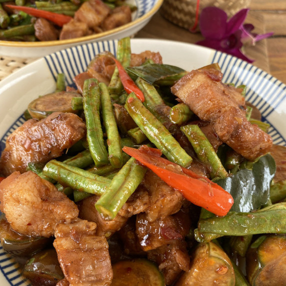 Thai red curry stir fry or pad prik gaeng on a white dish.