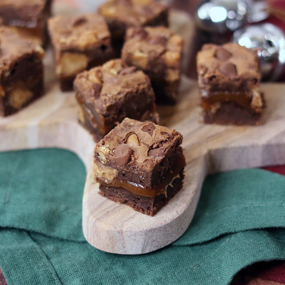 Peanut Butter Cup Caramel Brownies arranged on a holiday plate.