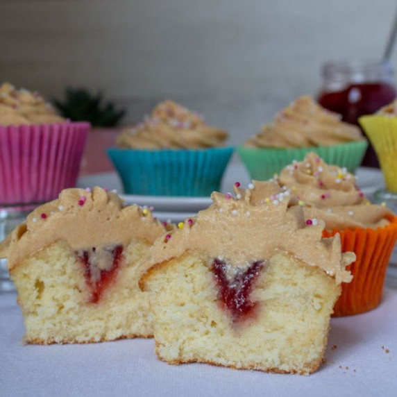 peanut butter and jelly cupcake cut in half to show the jelly filling
