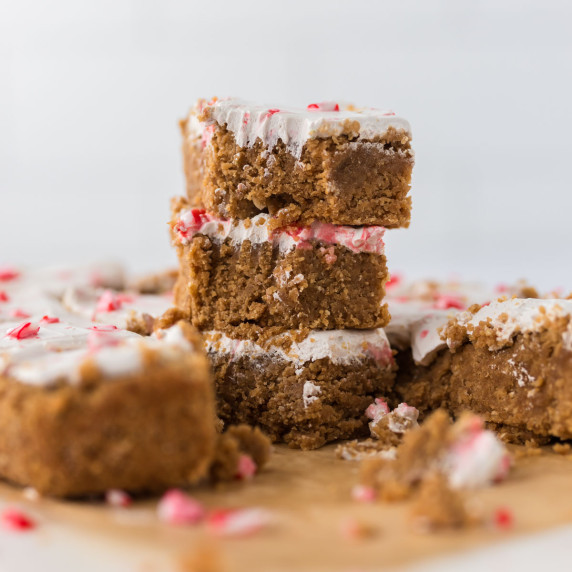 3 Peppermint Sugar Cookie Bars with bite taken out stacked on top of each other with bars around.