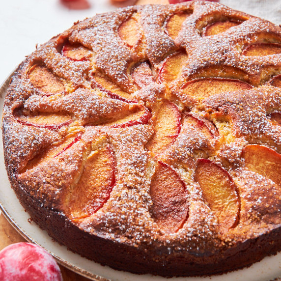 Protein Yoghurt Plum Cake with Sourdough on a plate, showing the arranged plum slices in the batter