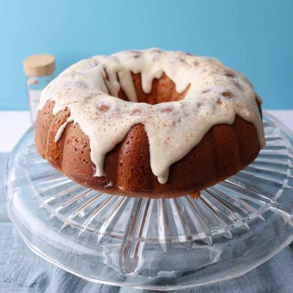 Pumpkin Cream Cheese Pound Cake with a thick cream cheese glaze and cinnamon sprinkle, served on a c