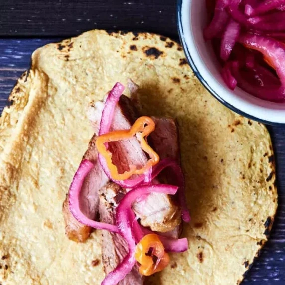 Ribeye steak tacos paired with a fruity, spicy red onion habanero salsa served with corn tortilla