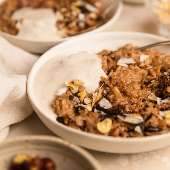  A bowl of rice chocolate rice pudding on a table surrounded by more bowls
