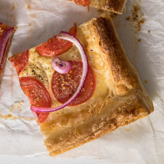 Sliced tomato puff pastry tart.