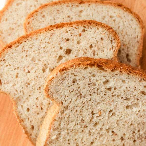 gluten free sandwich bread sliced on wood cutting board
