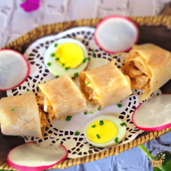 Shrimp popiah wrapped with peanuts, bean sprouts, jicama, eggs, radish, and sauces in a brown basket