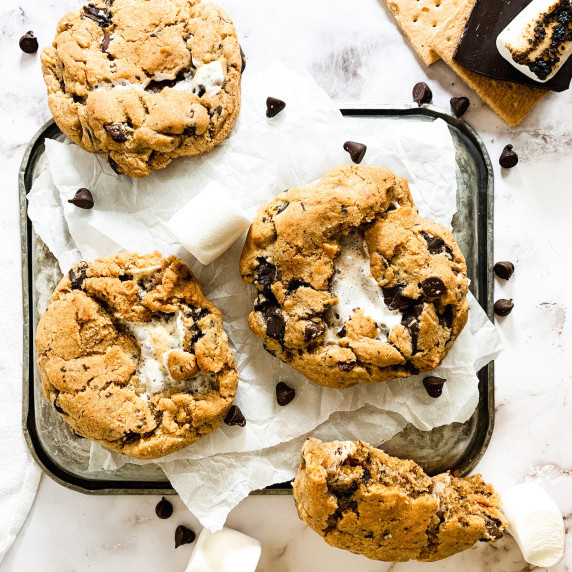 s'mores cookies on a cookie sheet with chocolate chips