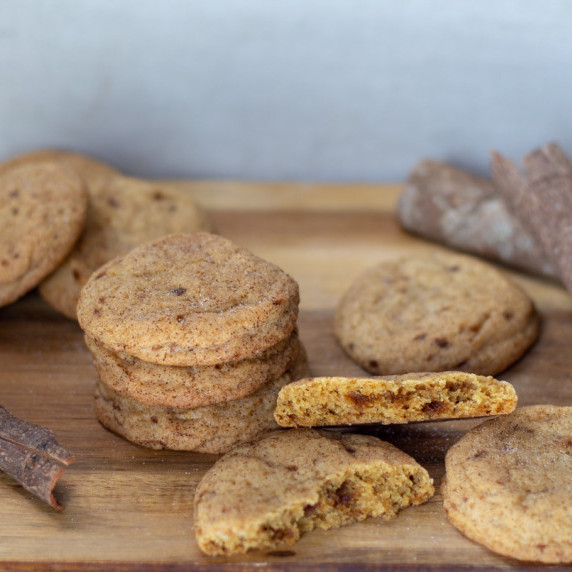 stacks of snickerdoodle cookies on a wooden board