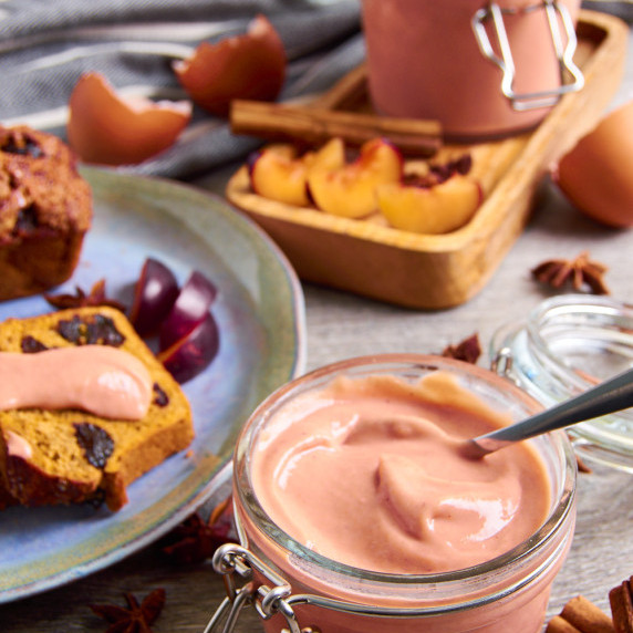 Jars of Spiced Plum Curd, surrounded by plums and anise stars. A plate with Pumpkin Soda Bread