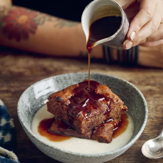 Warm sticky toffee pudding with a moist date filled sponge cake drenched in caramel toffee sauce