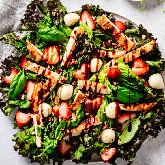 Strawberry chicken Caprese salad with grilled chicken, fresh strawberries, mozzarella balls, basil, 