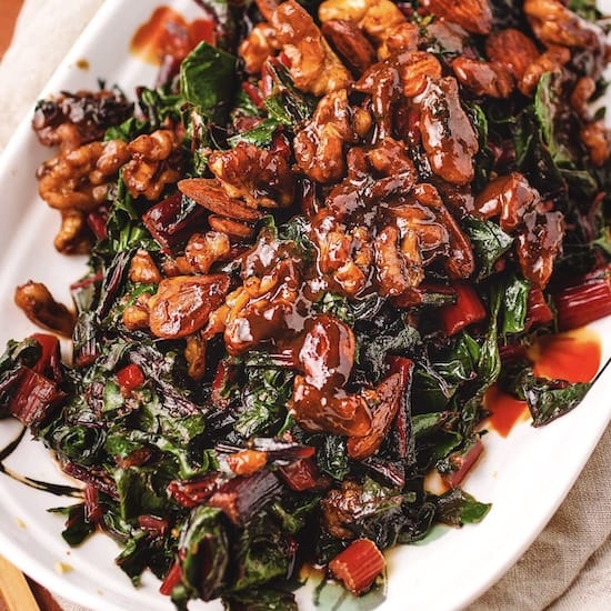 Swiss chard in chickpea miso butter on a white plate
