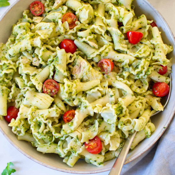 Tuna pesto pasta in a bowl with a serving spoon