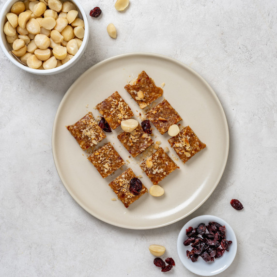 Tahini and macadamia nut fudge arranged on a plate on a white countertop