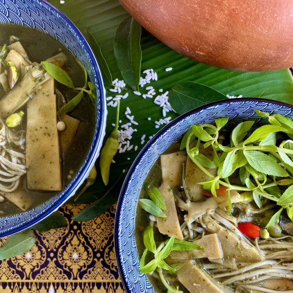 2 portions of Thai bamboo soup in patterned bowls.