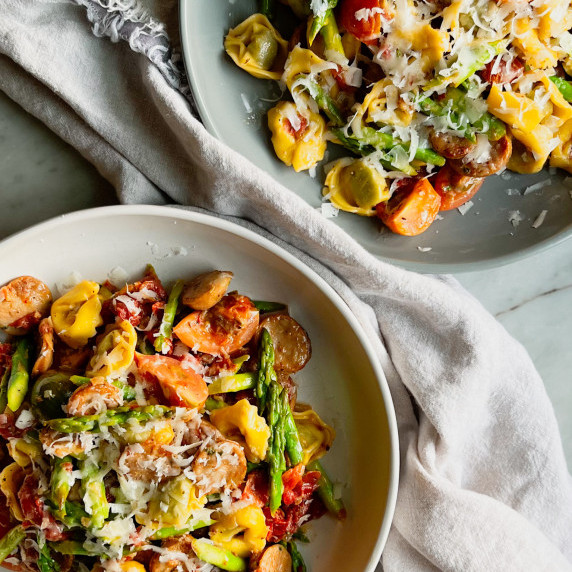 2 bowls of Trader Joe’s Tortellini with chicken sausage and asparagus
