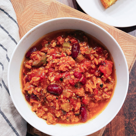 spicy turkey chili with beans in a white bowl
