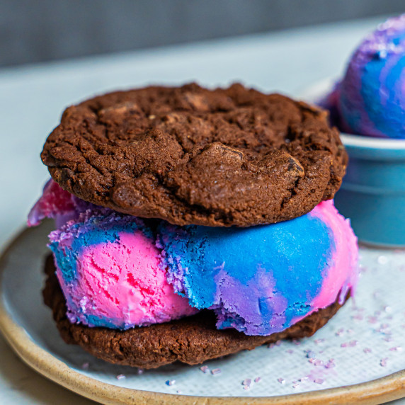 Pink, purple, and blue galaxy ice cream in chocolate chip ice cream sandwich