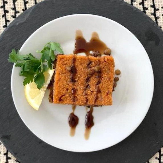 Baked vegan kibbeh drizzled with pomegranate sauce