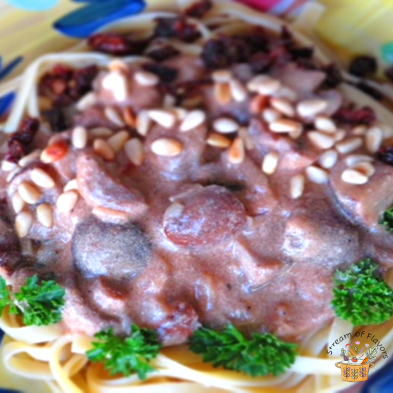 Vegetarian Mushroom Stroganoff topped with pine nuts, mushrooms, parsley and sun dried tomatoes