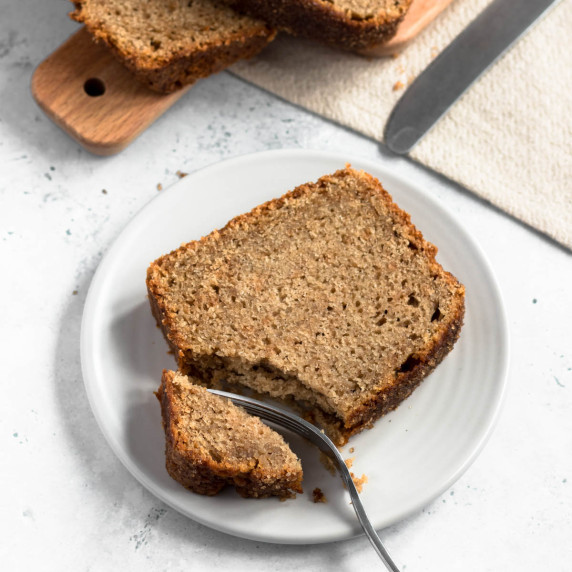 A slice of apple cinnamon loaf cake on a plate.
