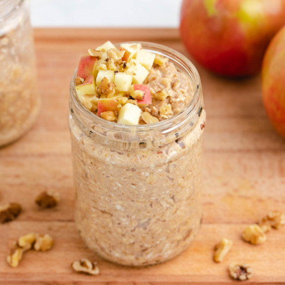 Applesauce overnight oats in a jar with diced apples.
