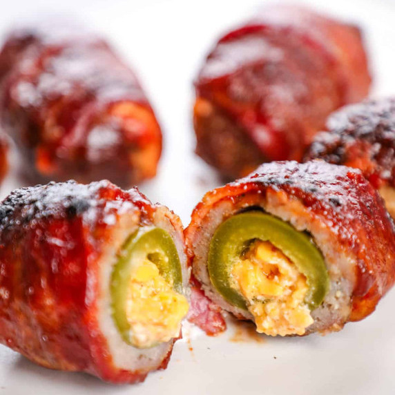 an armadillo egg with a cheese stuffed jalapeno wrapped in bacon and sausage.