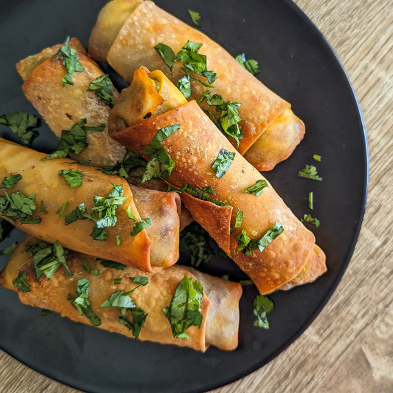 A plate of crispy air fryer avocado chorizo spring rolls