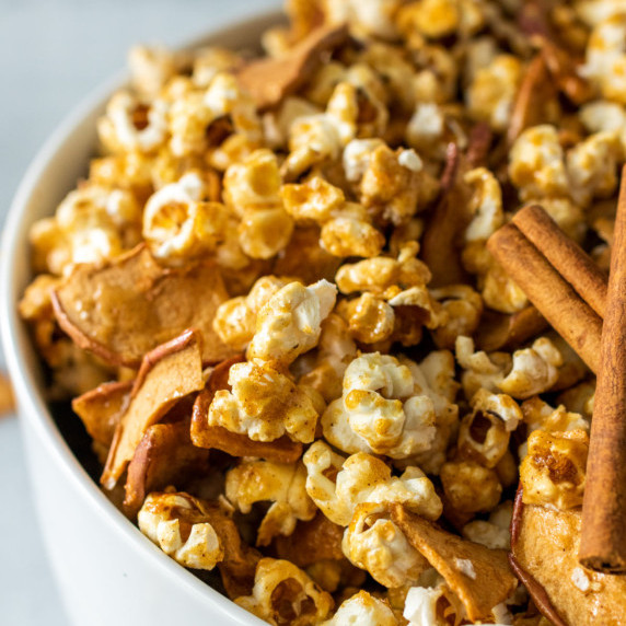A white bowl with caramel apple popcorn.