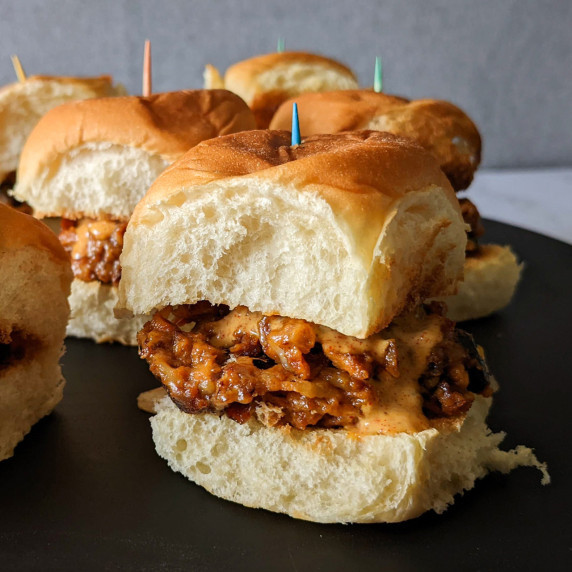 A platter of cheesy black bean sliders on Hawaiian rolls