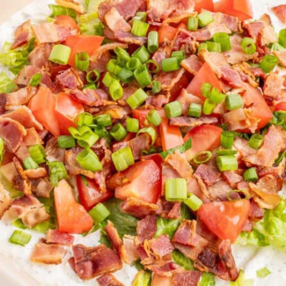 This creamy BLT Dip combines crispy bacon, fresh veggies, and tangy seasonings