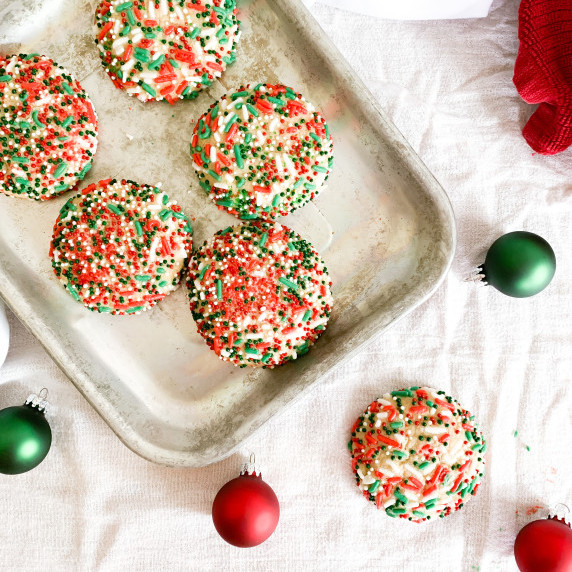 Sprinkle brown sugar cookies on a small baking sheet on a white table cloth