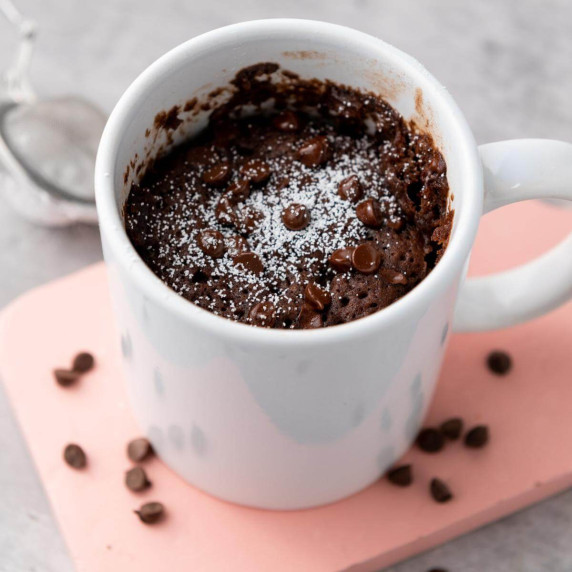 A cooked brownie in a mug.