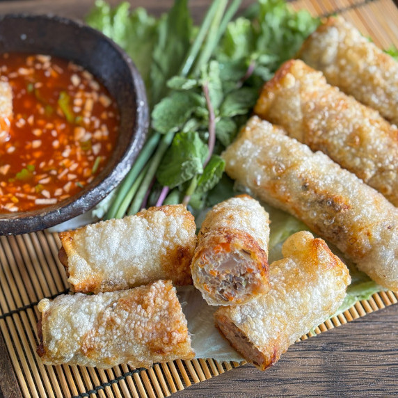 Top-view of cha gio, Vietnamese fried spring rolls, served with dipping sauce.