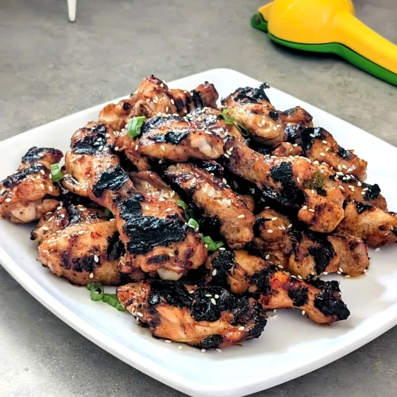 A plate of chicken wings topped with sesame seeds.