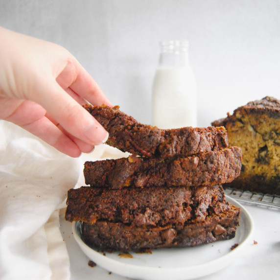 stack of slices of chocolate chip streusel banana bread on white plate