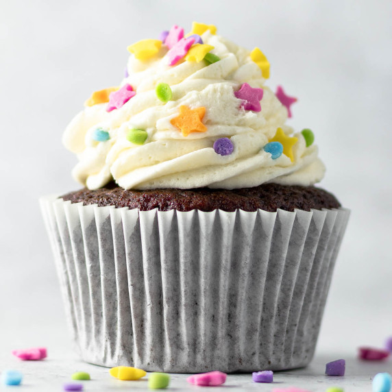 Chocolate cupcake topped with vanilla buttercream and sprinkles.