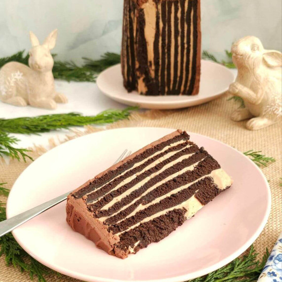 Image of a slice of chocolate orange Swiss roll cake, with vertical pattern instead of rorizontal.