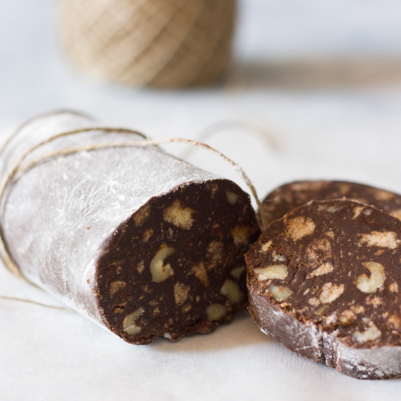 chocolate salami dessert wrapped in kitchen twine on a white countertop