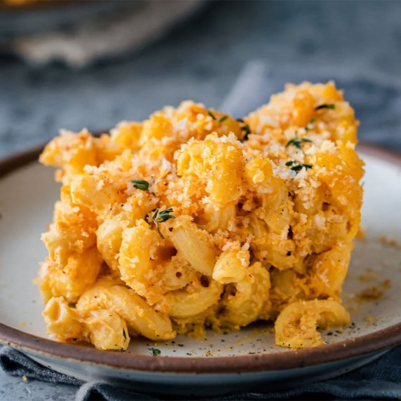 Section of crispy baked mac and cheese on a small plate.