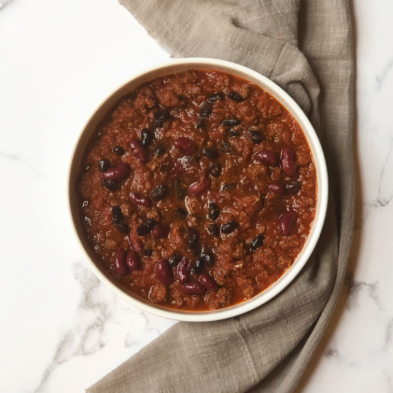Mild beef chili with beans in a white dish