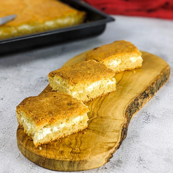 Three feta bread slices on a wooden board.