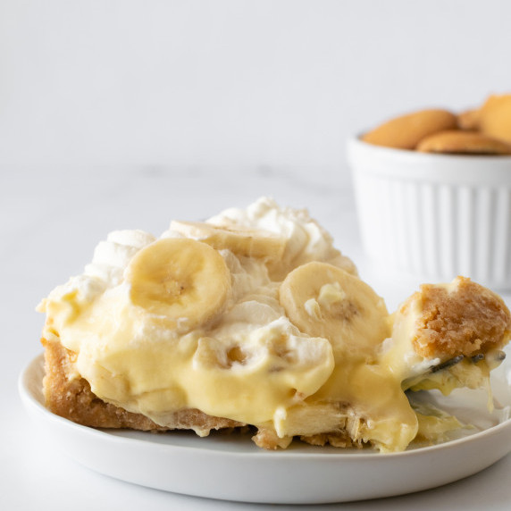 slice of banana pie on a white plate with a fork.